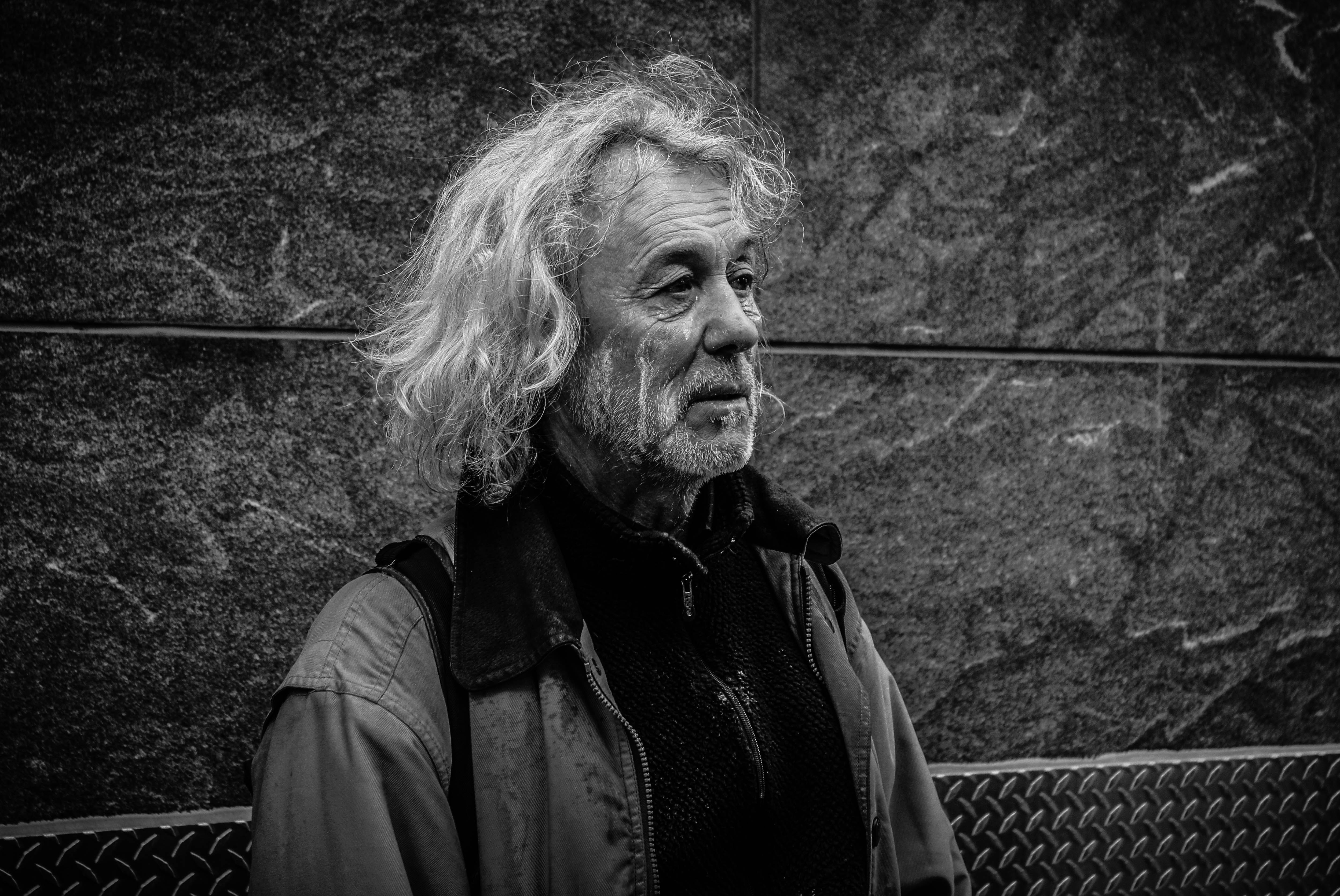grayscale photo of long-haired man